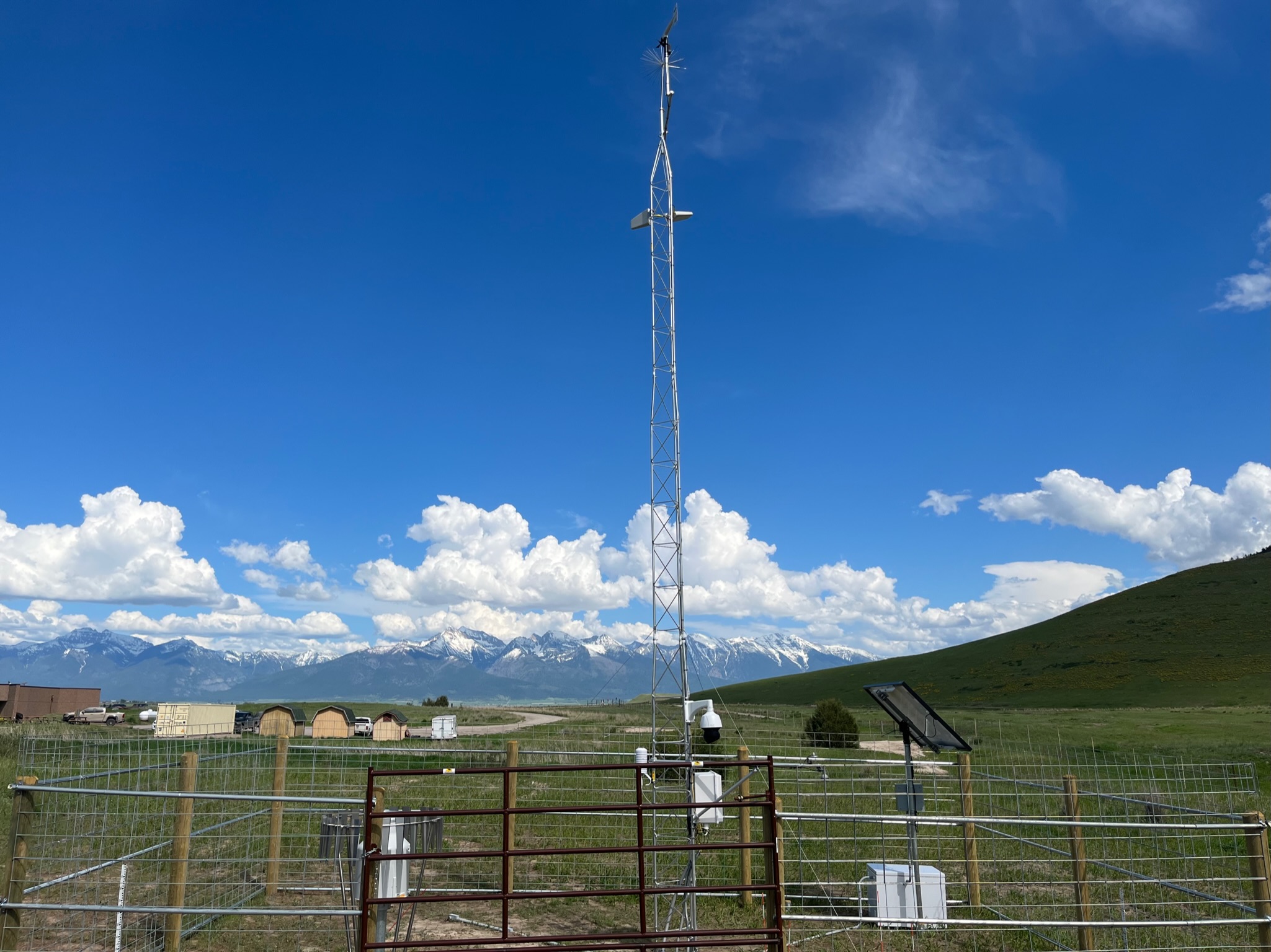 Mesonet Station Tall metal pole against background of mountains and grassland