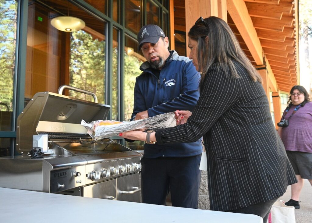 Dan Coen and Vicki Hebb move Lahontan cutthroat trout to the grill.