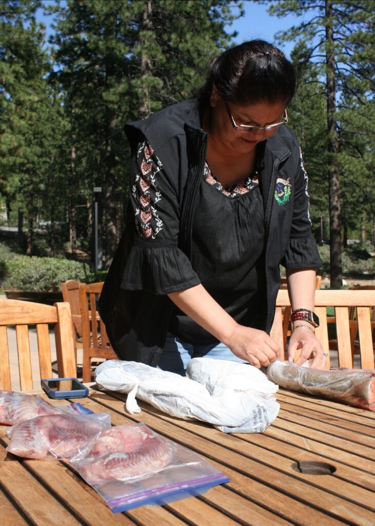 Laurie Thom removes fish from packaging.