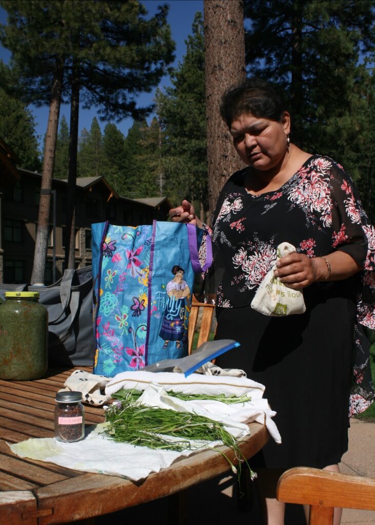 Melanie Smokey unpacks wild onions and other herbs.