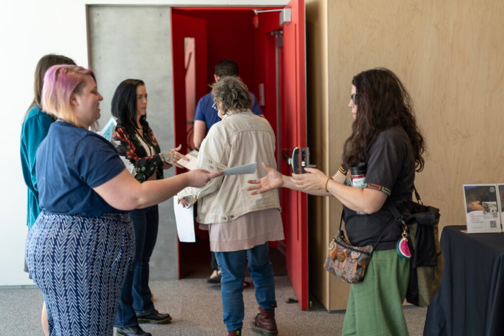 Session faciliatators handing materials to conference attendees