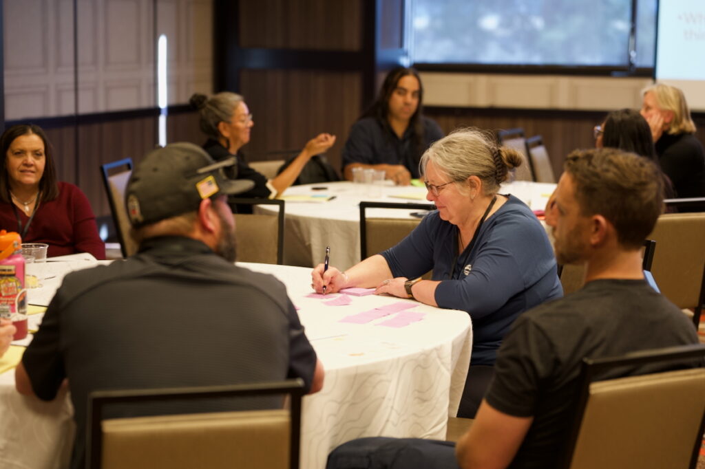Native Resilience program director Maureen McCarthy discusses climate change impacts with workshop participants. 